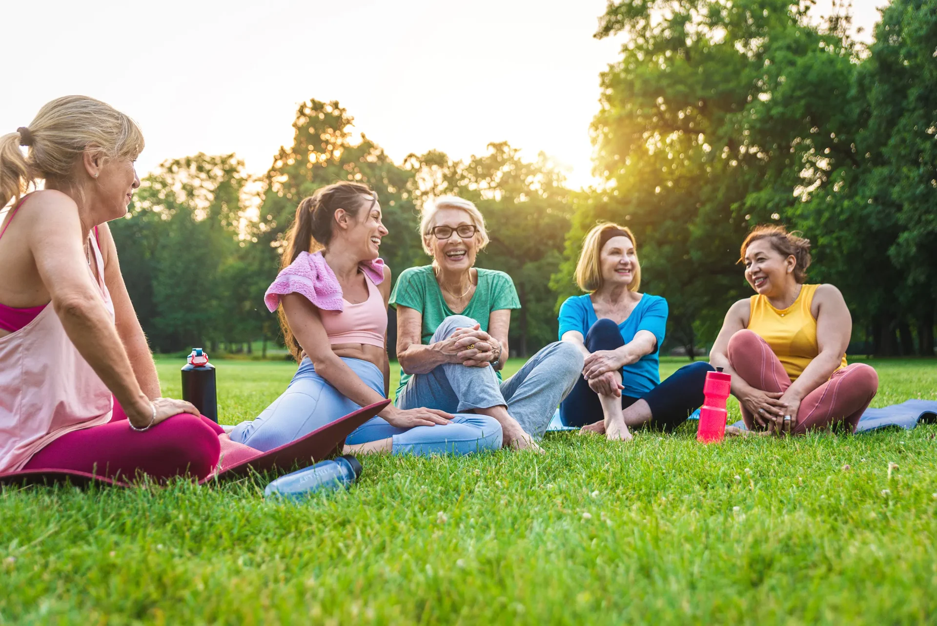 friends sitting grassy field